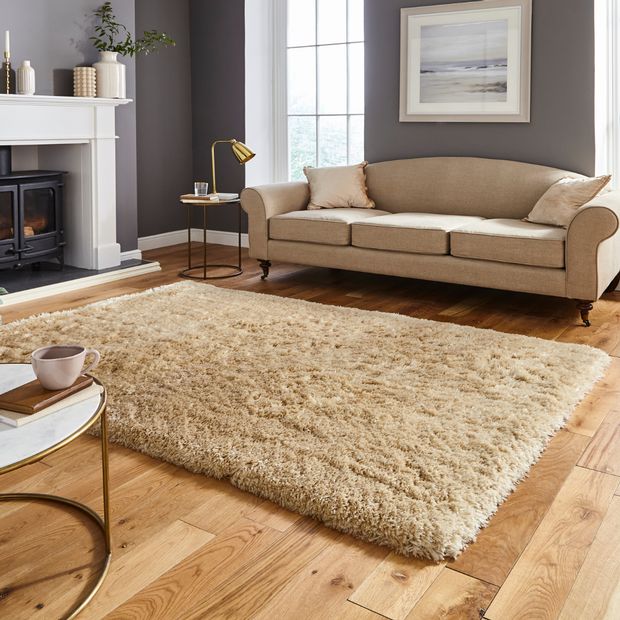 beige shaggy rug on a wooden floor